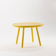 a yellow table sitting on top of a white floor