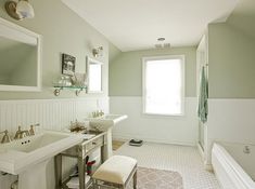 a white bathroom with two sinks and a bathtub