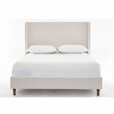 a white bed with two pillows on it's headboard and night stands next to it