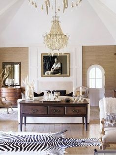 an image of a living room with zebra rugs on the floor and furniture in the background