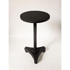 a small black table sitting on top of a white floor