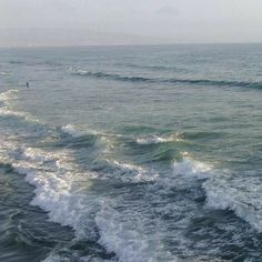 two surfers are riding the waves in the ocean