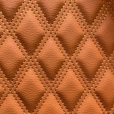 an orange leather texture with yellow stitching and diamond pattern on the inside of it