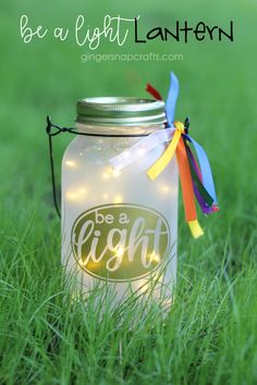 a mason jar with lights in it sitting on the grass