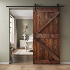 an open wooden door leading to a bedroom