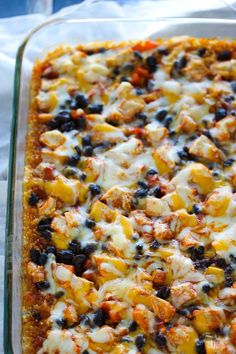 a casserole dish with chicken, black olives and cheese