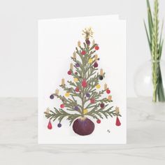 a card with a christmas tree on the front and an eggplant in the back