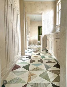 the hallway is decorated with colorful tiles and wood