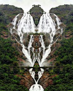 an abstract image of waterfalls in the middle of a mountain range with trees surrounding them