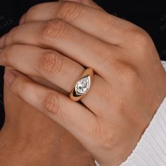 a woman's hand with a diamond ring on it