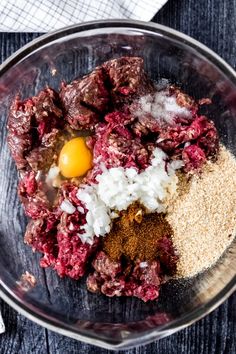 meat, rice and an egg in a glass bowl