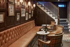 the interior of a restaurant with brown leather booths