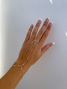 "Dainty 18k gold plated/platinum plated hand chain. Our hand chain is so flattering and comfortable to wear. Our chain is sparkly and sits so beautifully on the hand. Layer with some of your favourite rings and bracelets. We have always been obsessed with hand chains so we created our own. Hand chains are so dainty and give that extra sparkle and shine to your hands. Measurements:  Bracelet - 6.5-7\" inches (comes with extra adjustable 2\" chain extender) Wrist to finger - 7 cm Please feel free to send us over your measurements and we will make it a perfect fit for you! Message us or leave a note on your order with your measurements ♡ -  PROCESSING TIME -  This piece is handmade to order and is ready to ship in 1-2 business days.  - ABOUT MINKKSI -  https://www.etsy.com/shop/MINKKSI/about Permanent Hand Chain, Silver Chain Link Jewelry For Wedding, Gold Plated Silver Chain Ring With Adjustable Chain, Dainty White Gold Chain Bracelet, Tarnish Resistant, Adjustable Elegant White Gold Chain Ring, Dainty Tarnish-resistant White Gold Chain Bracelet, Elegant Adjustable White Gold Chain Ring, Elegant White Silver Chain Bracelet, Silver Dainty Chain Ring