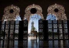 an iron gate with a clock tower in the background