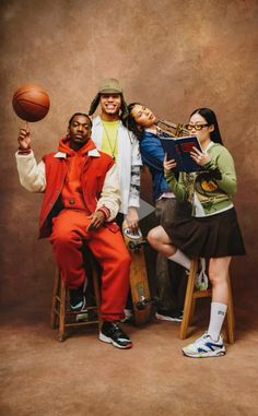 three people are posing for a photo with a basketball in front of them and the man is holding a book