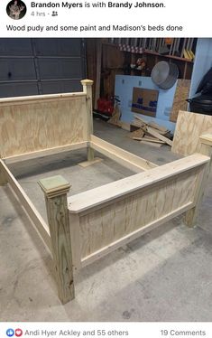 a bed frame made out of plywood and wood