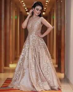 ”Glamour Gown” Feauturing a stunning indo western flaired gown.   Price - INR 44000 Shipping Worldwide.  Fabric - Silk.  Work - Swarovski, Sequence, Zari.   *Custom made outfit, can be made in any color of choice.  For price, orders & other information  DM or Whats App on +91 9930089059  Happy Shopping. Ruffel Sarees, Glamour Gown, Gowns Indian, Wedding Reception Outfit, Golden Gown, Reception Gowns