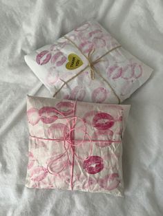 two pillows with pink and white designs on them