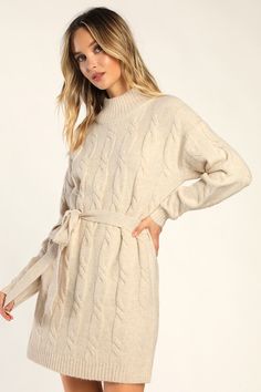 Bundling up for the season has never looked so fabulous thanks to the Lulus Warmed Up To You Cream Cable Knit Mock Neck Sweater Dress! Thick, cozy wool-blend cable knit shapes a mock neckline, long sleeves, and a relaxed bodice. The shift silhouette falls to a cute mini hem and features a tying belt that allows you to cinch the waist. Contrasting ribbed knit accents the neckline, cuffs, and hem. Fit: This garment fits true to size. Length: Mid-thigh. Size medium measures 32.5" from shoulder to h Fall Cable Knit Sweater Dress, Cozy Cable Knit Dresses For Fall, Cozy Cream Sweater Dress For Fall, Cozy Long Sleeve Cable Knit Dress, Cozy Cable Knit Long Sleeve Dresses, Cozy Cable Knit Spring Dress, Cozy Cable Knit Sweater Dress For Fall, Cozy Cable Knit Sweater Dress For Spring, Beige Cable Knit Sweater Dress