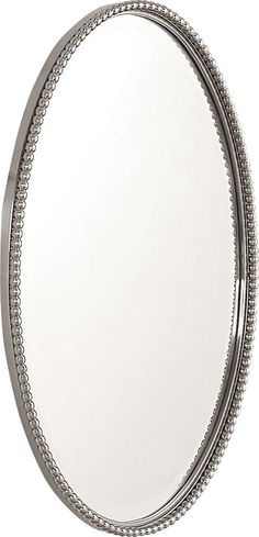 a round mirror with beaded trim around the edges