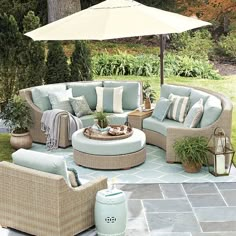 an outdoor patio with furniture and umbrella