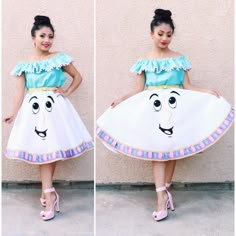 a woman in a white dress standing next to a wall with two pictures of her face