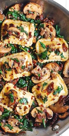 a pan filled with chicken and spinach covered in sauce