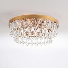 a chandelier hanging from the ceiling with clear glass drops on it's sides