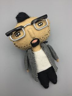 a stuffed animal wearing glasses and a sweater