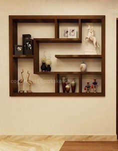 an empty room with wooden shelves and vases on the wall next to a door