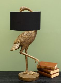 a lamp that is on top of a table next to some books and a book