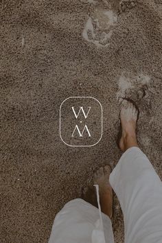 a person standing in the sand with their feet on the ground and an x logo above them