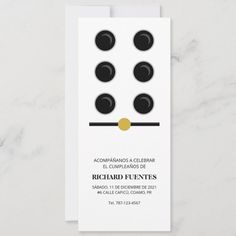 a white business card with black and gold dots