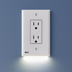 a white light switch on a blue wall with two lights in the middle and one is turned on