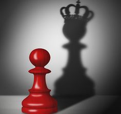 a red chess piece with a crown on top