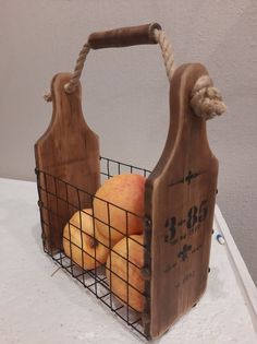 a basket filled with fruit sitting on top of a white table next to a wall