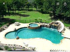 an aerial view of a swimming pool surrounded by trees