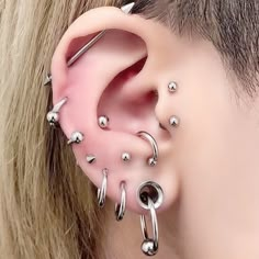 an ear with several piercings attached to it