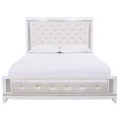 a white bed with an upholstered headboard and foot board on the side