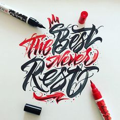 some type of lettering that is on top of a white surface with red marker pens