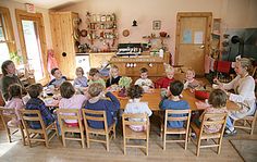 a group of people sitting around a wooden table