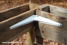 a close up of a white object attached to a wooden fence