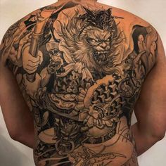 the back of a man with tattoos on his body