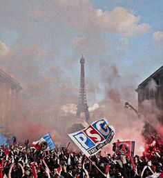 a large group of people holding signs and flags in front of the eiffel tower