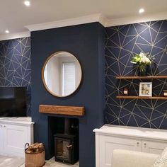 a living room with blue walls, white furniture and a large mirror on the wall