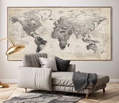 a living room with a couch, rug and large map on the wall above it