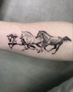 three running horses tattoo on the arm