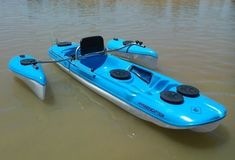 a small blue boat floating on top of a body of water