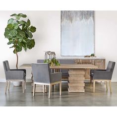 a dining room table with chairs and a potted plant