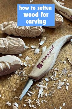 a wooden carving knife sitting on top of a table next to wood shavings